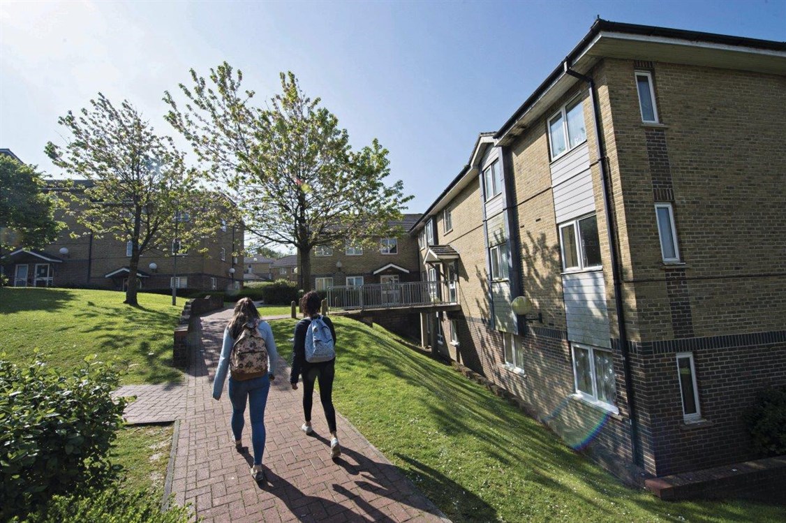 Students walking though university accommodation
